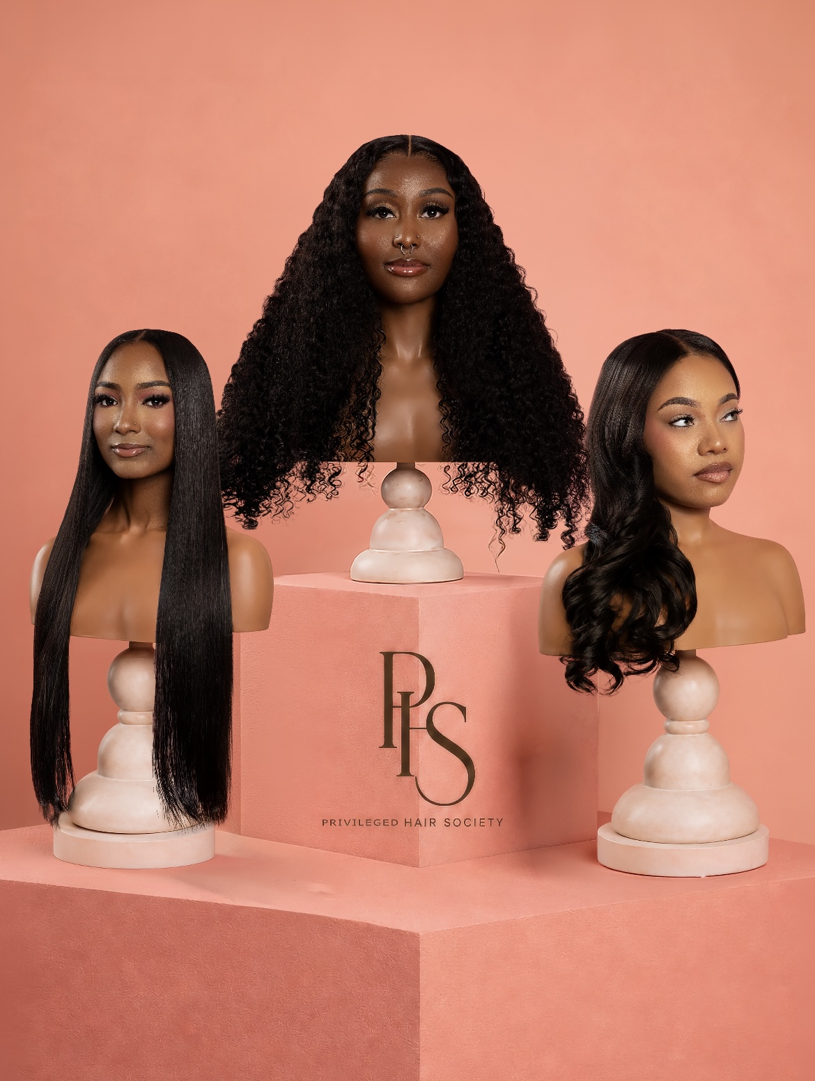 Three luxury wig mannequins showcasing straight, curly, and body wave textures on a salmon pink PHS display