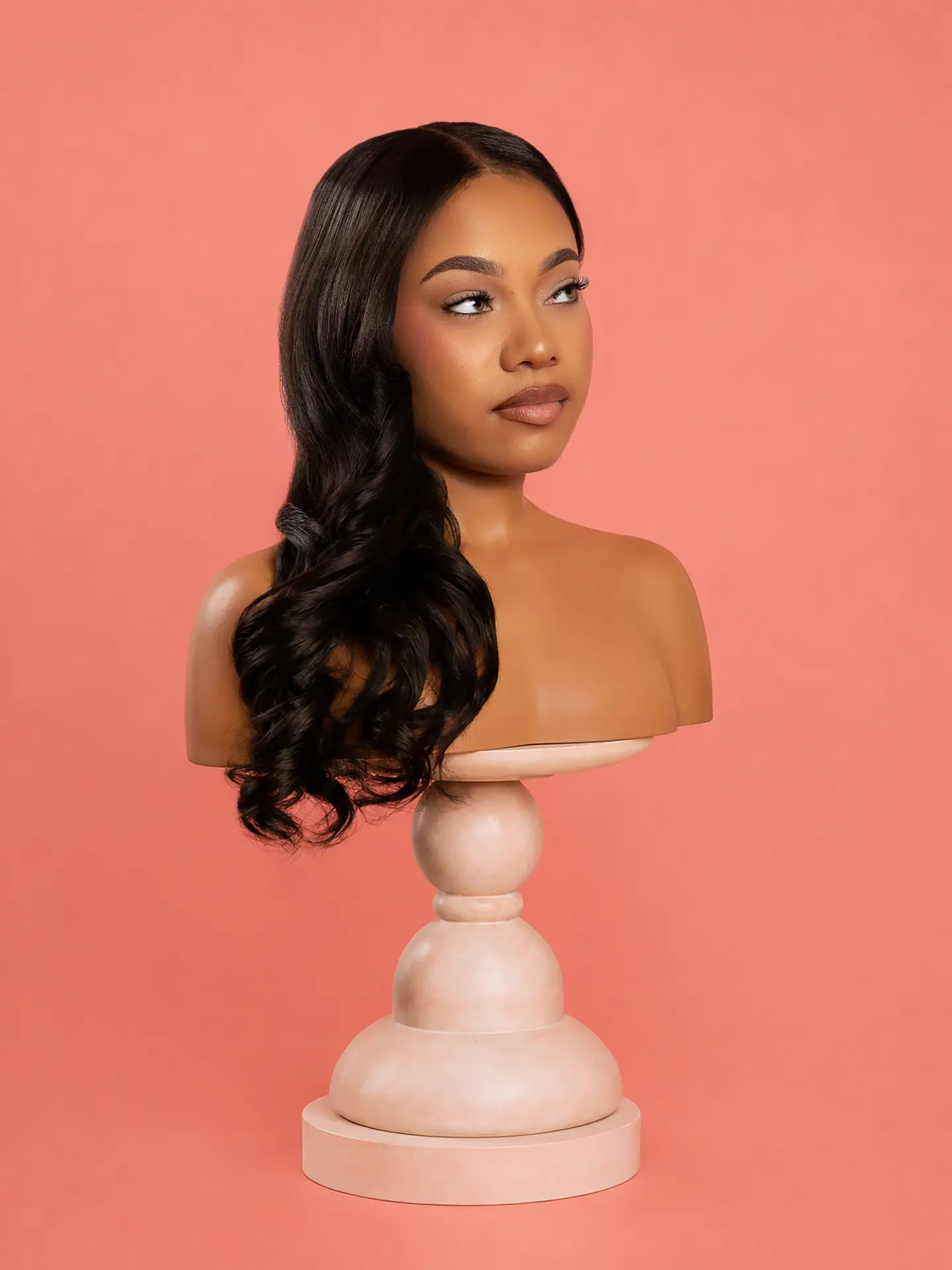Blush Wave — Body Wave luxury wig on mannequin against a salmon pink backdrop